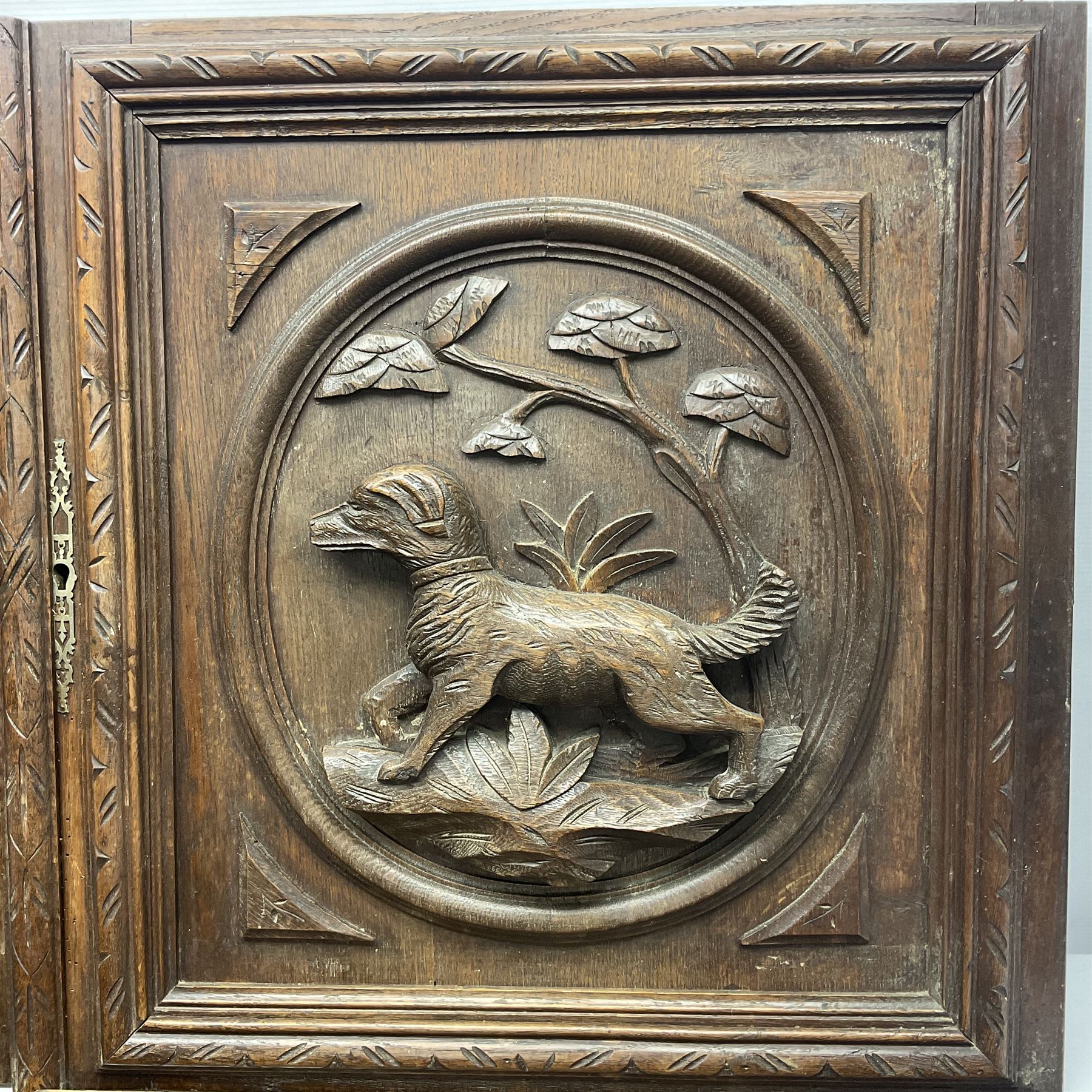 Pair of oak furniture door panels, carved in relief with a fox to one and a hound to the other, together with a pair of smaller oak panels, carved in relief with a hare to one and a grouse to the other, doors W63.cm x H62cm, panels W43cm x H60cm