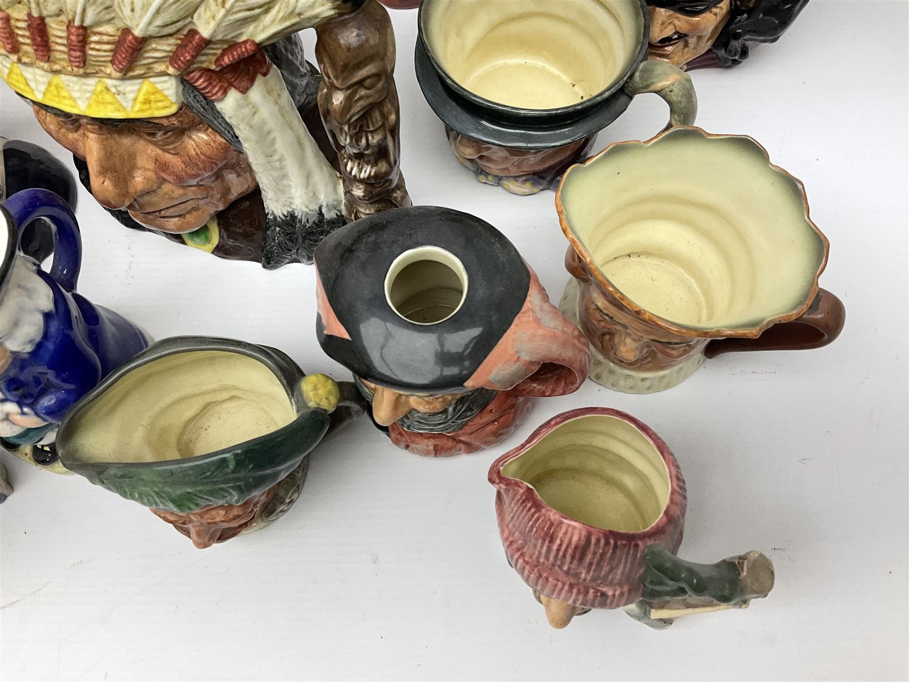 Collection of Royal Doulton and Beswick character jugs of various sizes, including North American Indian D6611, The Falconer D6533,  Tony Weller 281, Sairey Gamp 371 etc