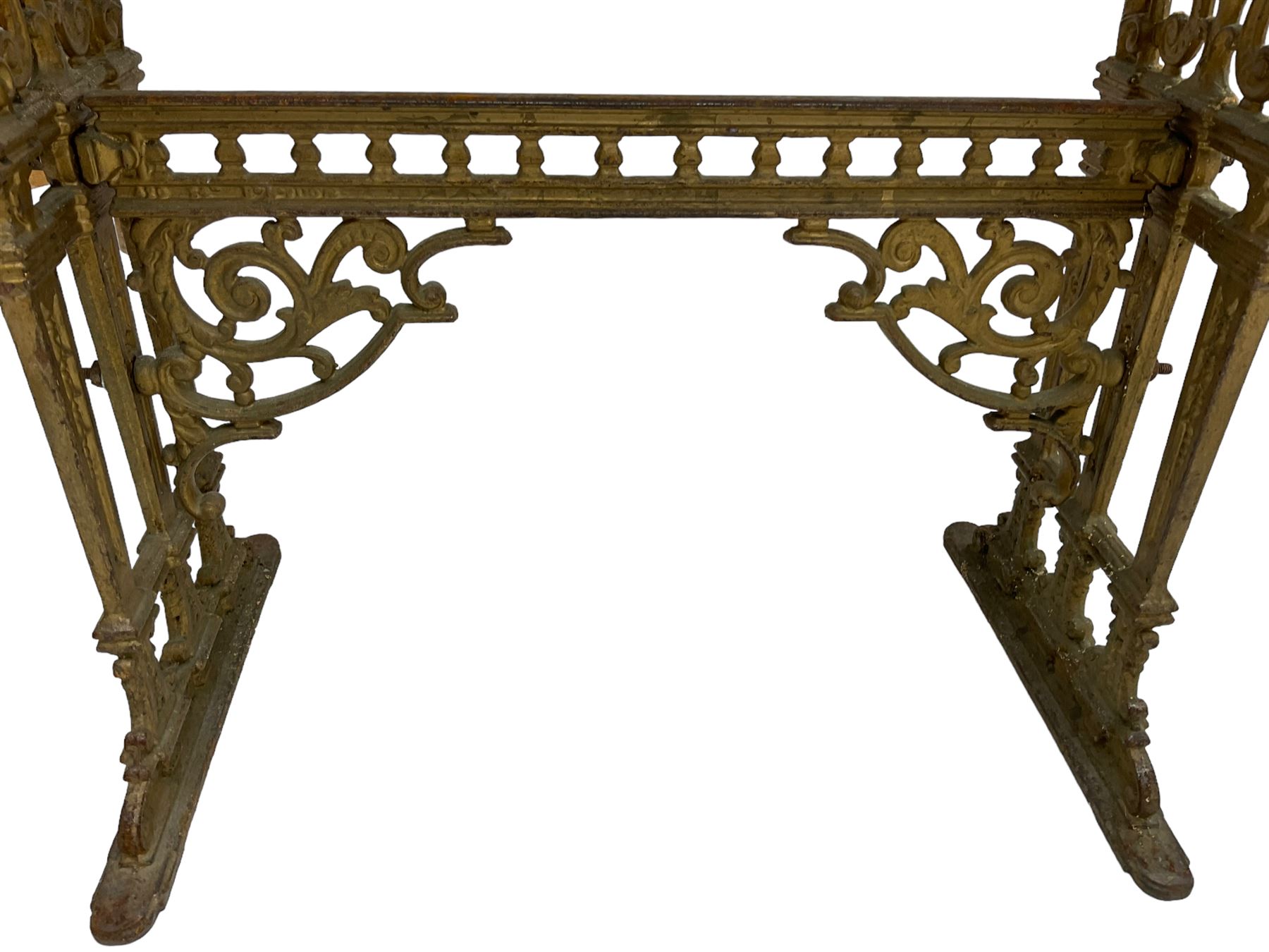 Pair of 19th century cast iron entrance tables, rectangular marble top over ornate gilt bases with scrolling foliate design and sledge feet, united by balustrade stretcher with scroll spandrels