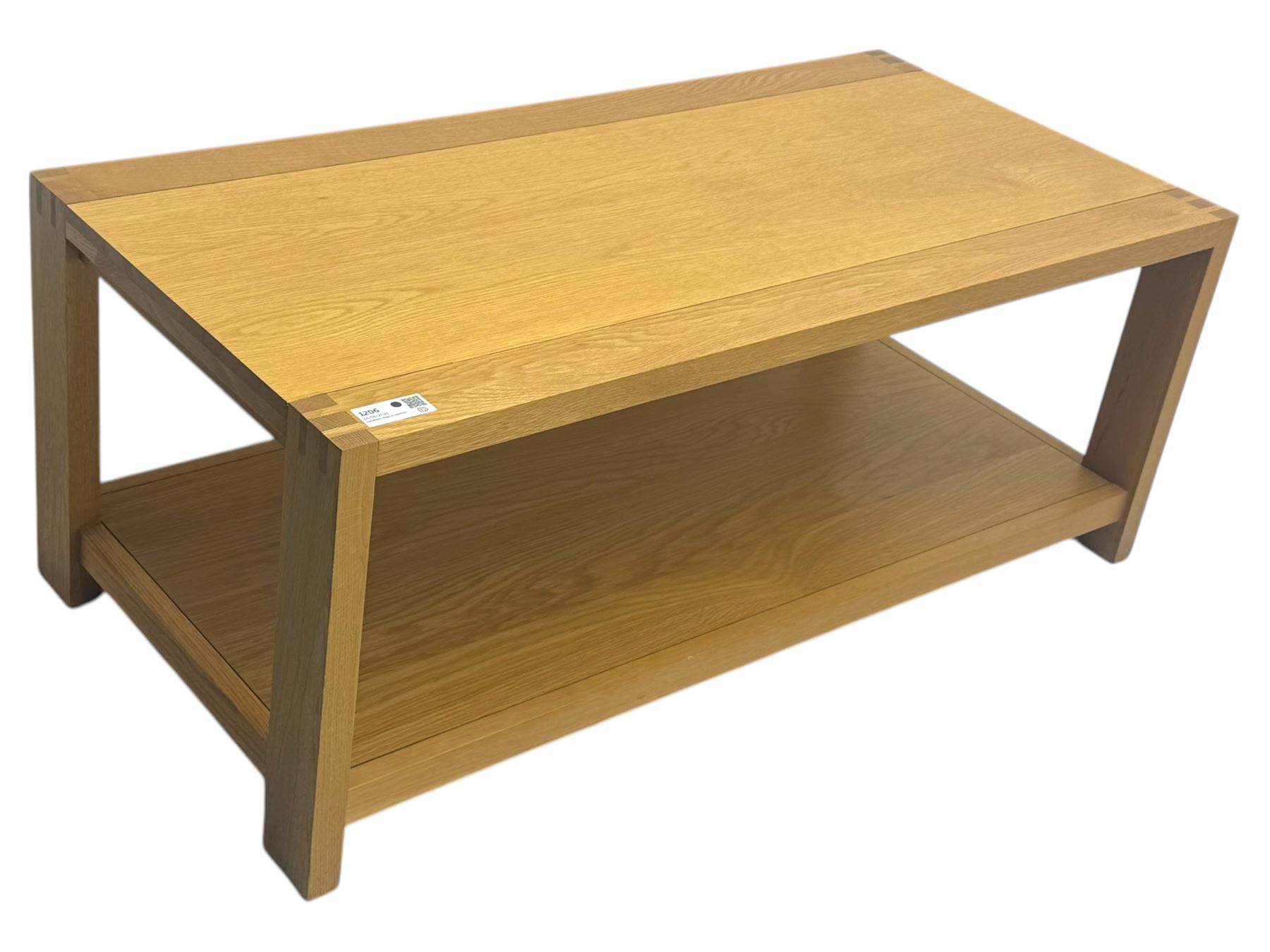Light oak rectangular coffee table, with exposed finger joints to the corners, raised above a full-length undertier on straight supports