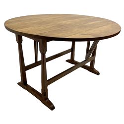 Gnomeman - oak dining table, circular adzed drop-leaf top, square tapered and chamfered supports on sledge feet, carved with gnome signature, by Thomas Whittaker of Littlebeck