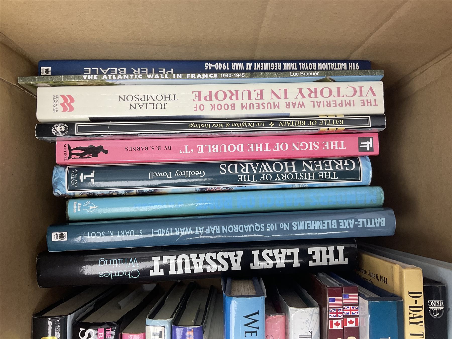 Large collection of hardback and paperback books, mainly military books, to include Band of Brothers, Dawn of D-Day, Dessert Warrior, Book of the Somme, Battle of Britain, etc in four boxes  