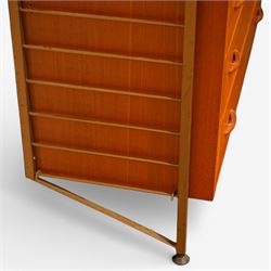 Staples - 'Ladderax' wall mounted modular teak unit, comprising two shelves, a fall front cabinet above three drawer unit below, supported on metal ladder frames 