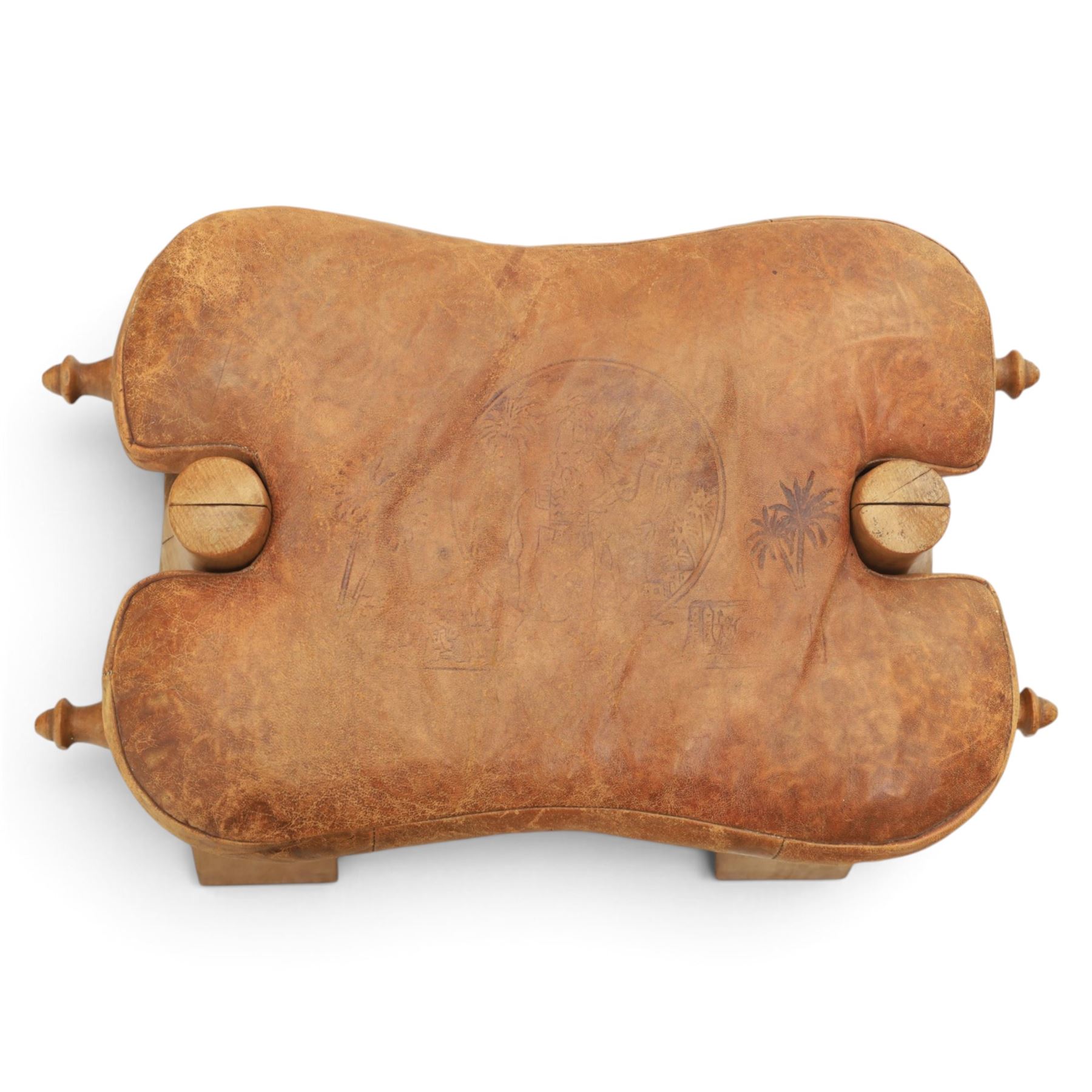 20th century Camel stool, tan leather seat with tooled design, raised on a light wood carved frame with camel design