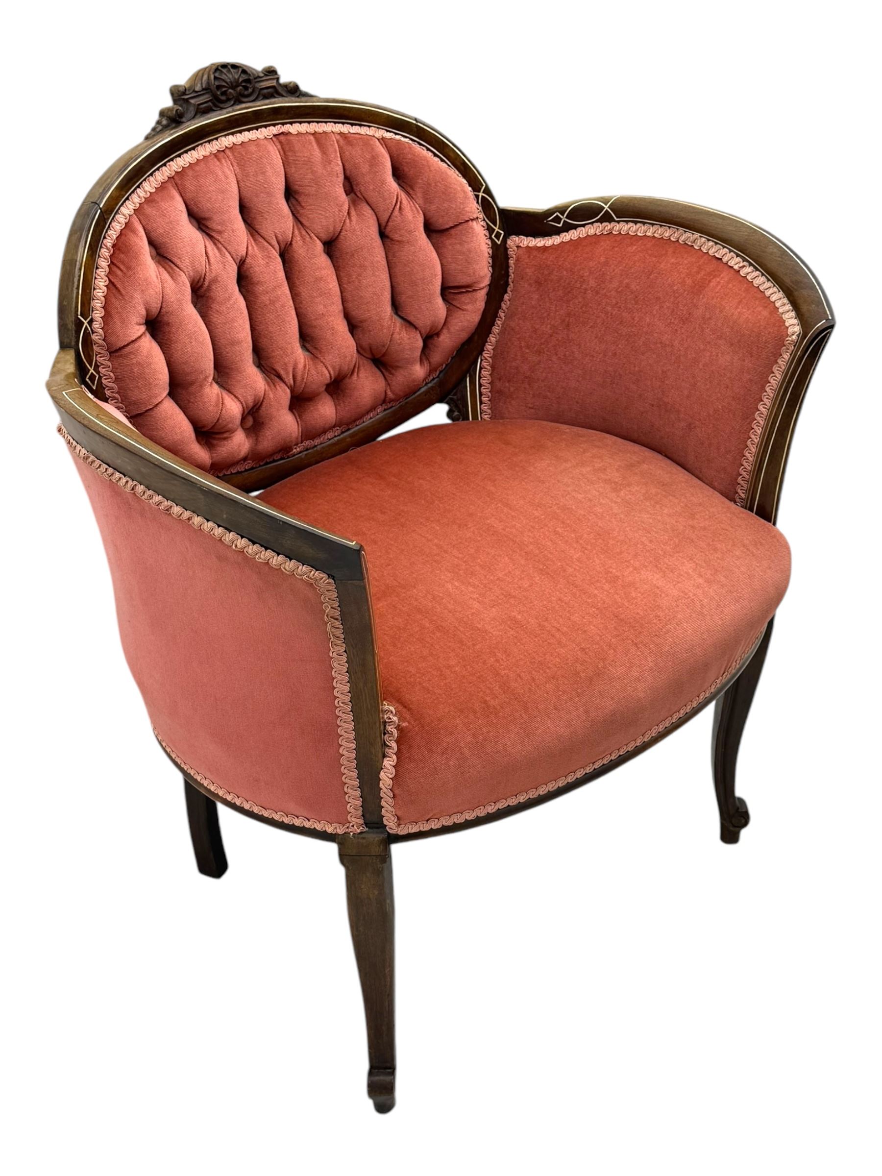 Edwardian inlaid rosewood parlour suite, comprising pair of tub shaped armchairs (W77cm, D69cm, H88cm); and matching two-seat sofa (W112cm, D69cm, H88cm), each with carved crest rails with shell motifs, deep button-tufted oval backs upholstered in pink fabric with braid trim, on cabriole supports