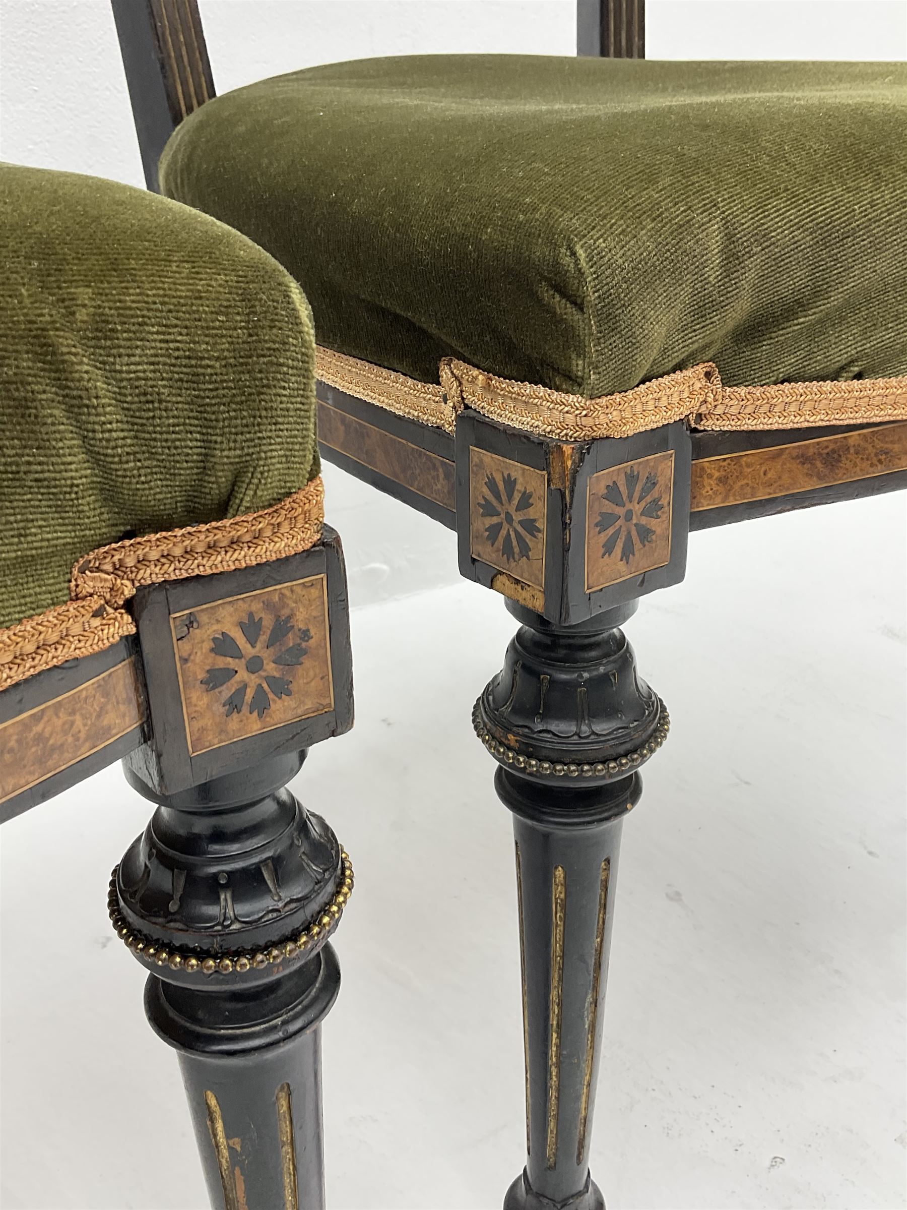 Set three late Victorian salon side chairs, ebonised frames inlaid with amboyna wood, with applied brass beading, turned and fluted supports with gilt detail