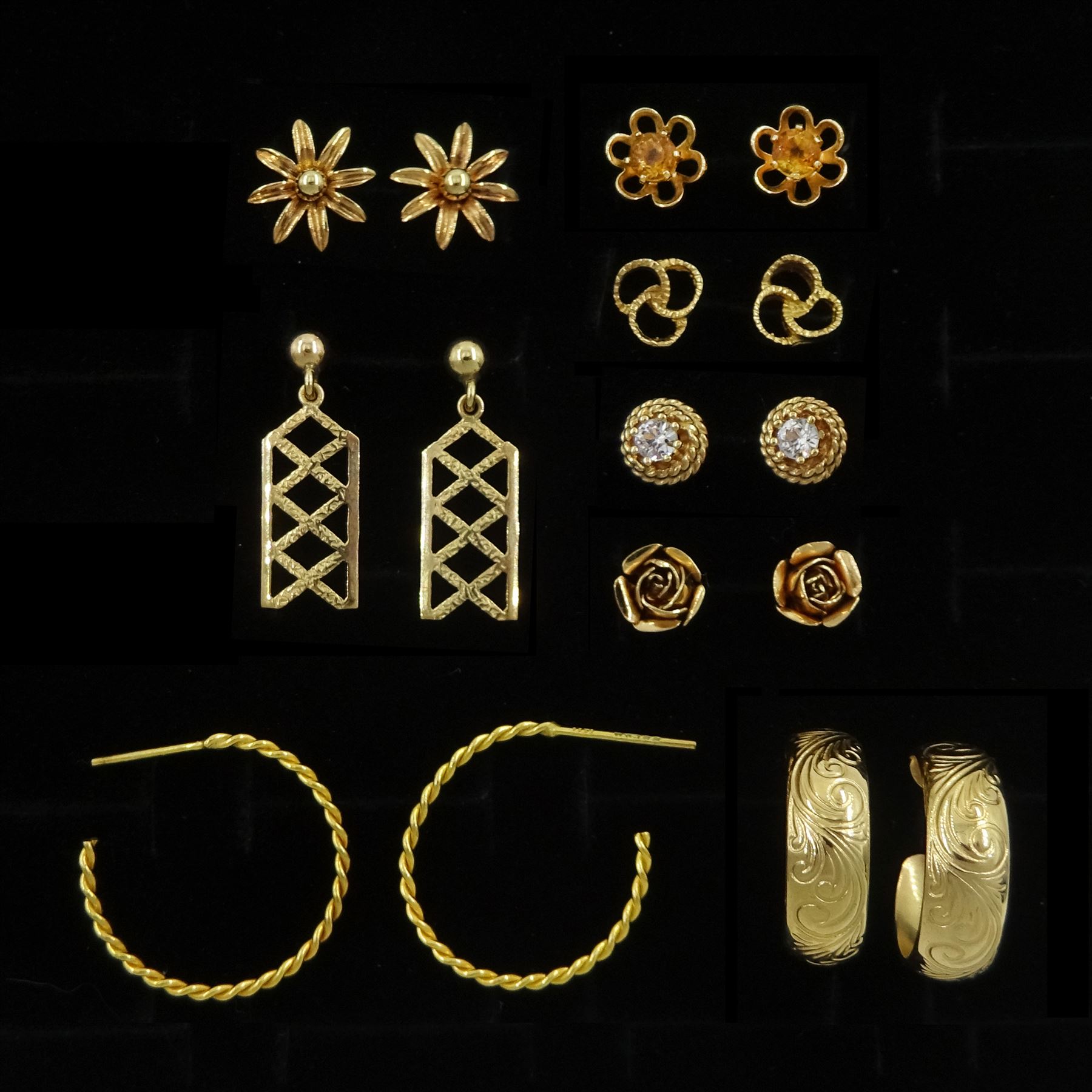 Eight pairs of 9ct gold earrings including flower head and hoop, all hallmarked