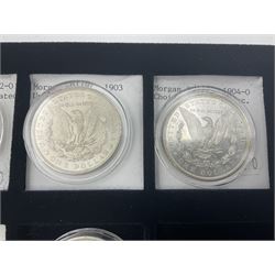 Seven United States of America silver Morgan dollar coins, dated 1884, 1901 O, 1902 O, 1903, 1904 O, 1921 D and 1921