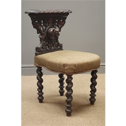  Late 19th century oak reading chair, carved with hound mask and foliage, barley twist supports, upholstered seat   