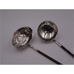 Two Georgian toddy ladles with silver bowls and baleen twist handles, the first example with circular bowl marked DF, probably for Donald Fraser, circa 1820, Inverness, H26cm, the second with oval bowl inset with George II 1758 coin, unmarked, both testing as silver, H33cm
