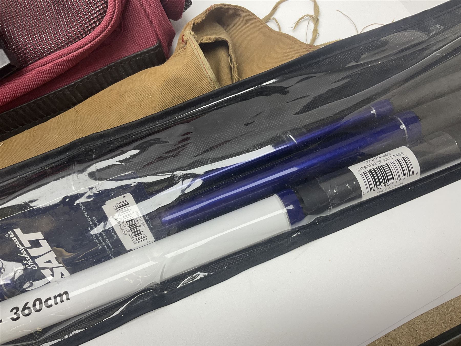 Collection of fishing memorabillia and equipment, including an Allcocks three piece split cane trout fly rod, Shakespeare Salt 3600 surf rod, two tackle bags, Old Red Seastreak multiplier reel, Sportext Saltwater fixed spool reel, fishing dvds, etc