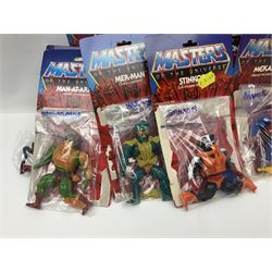 Thirty-one Masters of the Universe He-Man figures re-bagged on original backing cards;  two others lacking backing cards; boxed Modulok figure; bag of weapons and accessories; Roton, two horses and two battle cats; 1986 & 1987 Annuals; Ladybird and other story books; Panini sticker album; instructions etc