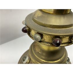 Brass alter cross, decorated with glass cabochons, upon a acicular stepped base and three claw feet, H73cm 