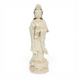Large Chinese blanc de chine figure of Guanyin, depicting the goddess stood upon a lotus leaf with one hand raised, with potters seal mark to the reverse, H75cm