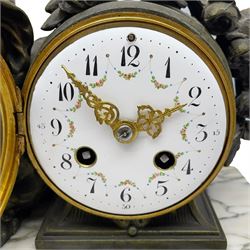 A French table clock c1900 on a white variegated rectangular marble base with four circular gilt feet, 8-day Parisian striking movement within a painted spelter drum case with putto, white enamel dial with floral garland decoration, Arabic numerals, minute track, gilt Louis XV hands and convex glazed bezel, movement striking the hours and half hours on a silvered bell. With Pendulum.  

