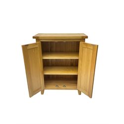 Solid light oak cupboard, fitted with two panelled doors enclosing two shelves, on tapered feet