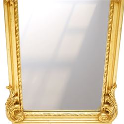 Pair of Rococo Revival gilt framed wall mirrors, the pierced scrolling rocaille pediment with foliate motifs over an oval panel with relief portraits of classically draped females, over a shaped rectangular bevelled plate surrounded by beading and scrolling foliate motifs