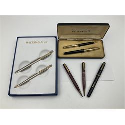 Group of Waterman pens and propelling pencils, to include a fountain pen, the black barrel with rolled gold cap and nib stamped 14ct, together with a matching propelling pencil, in box, together with a further fountain pen with gold nib stamped 14ct, stainless steel fountain pen and rollerball set in box, propelling pencil with maroon barrel etc, largest L13cm (7)