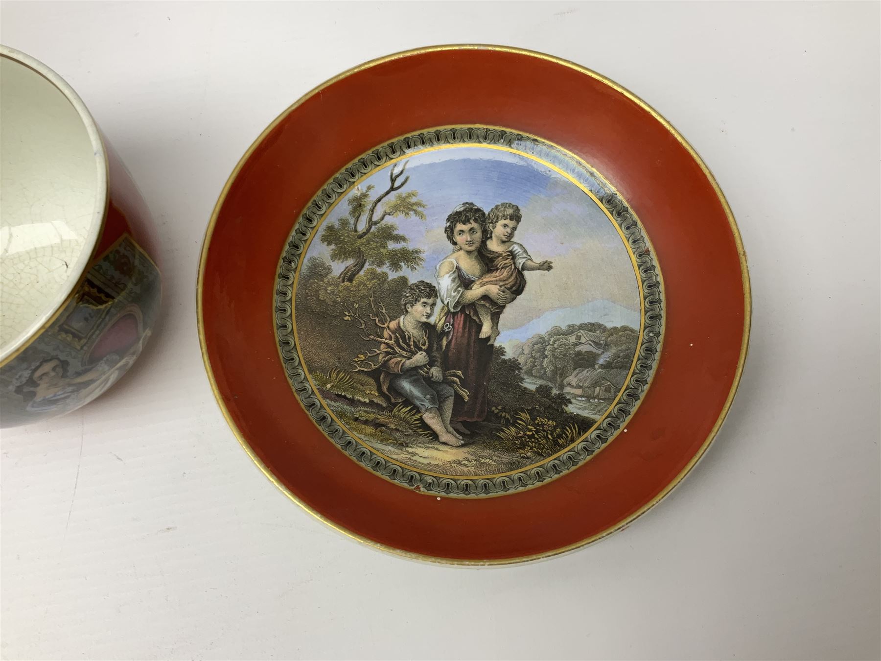 19th century Prattware table ware to include an oval footed dish decorated with a scene after Landseer 'Highland Music', retailed by James Muggleton L27.5cm, ‘The Truant’ plate after T. Webster, 'Blind Man's Buff' & 'Snap Dragon' tea plate, two side plates with malachite printed borders and others (17)