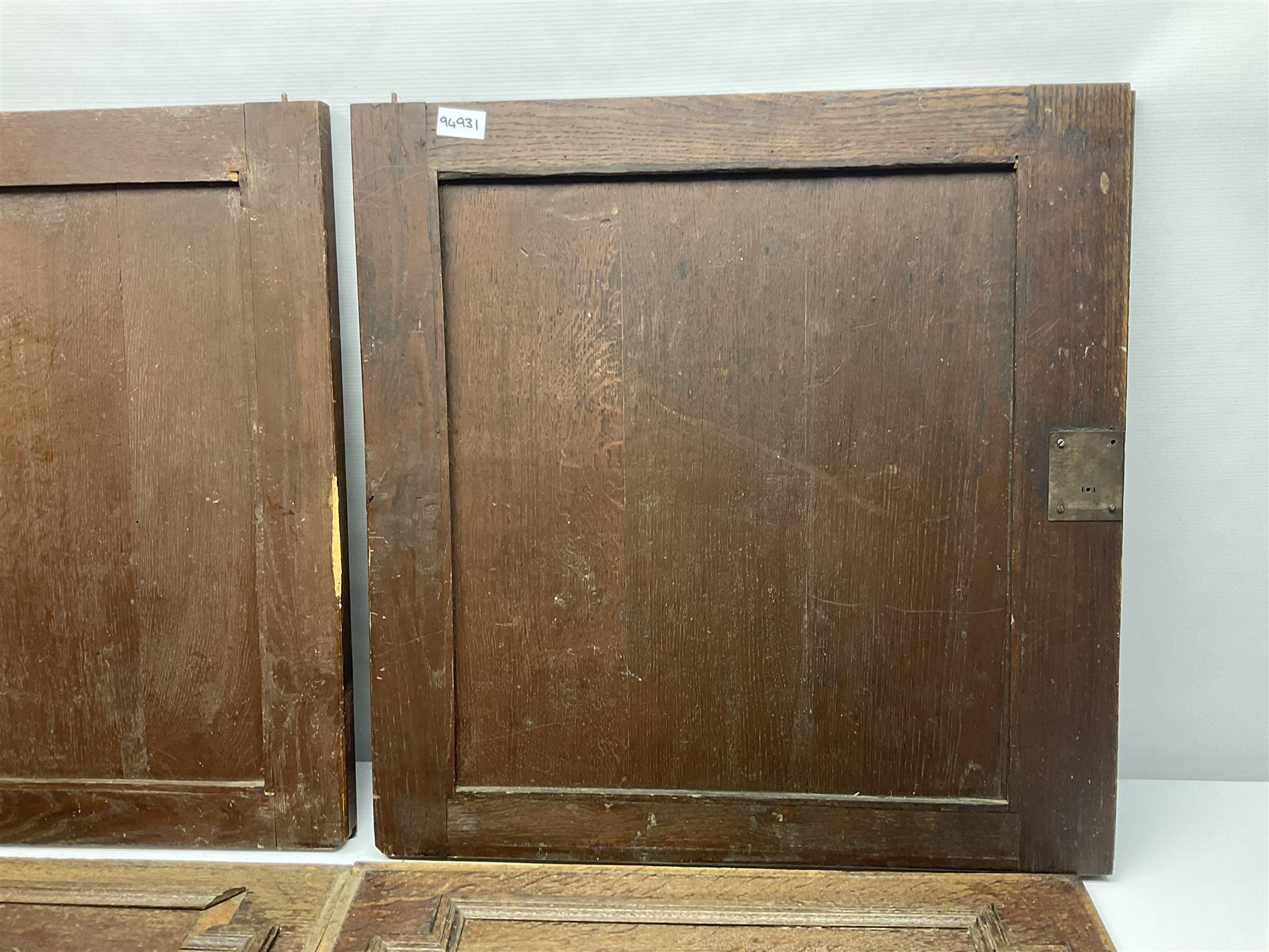 Pair of oak furniture door panels, carved in relief with a fox to one and a hound to the other, together with a pair of smaller oak panels, carved in relief with a hare to one and a grouse to the other, doors W63.cm x H62cm, panels W43cm x H60cm