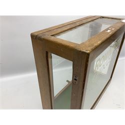 Rowntree's Chocolates oak display cabinet with glazed panels, the front with later painted lettering, the reverse with sliding panel, H38.5cm W41.5cm D19cm