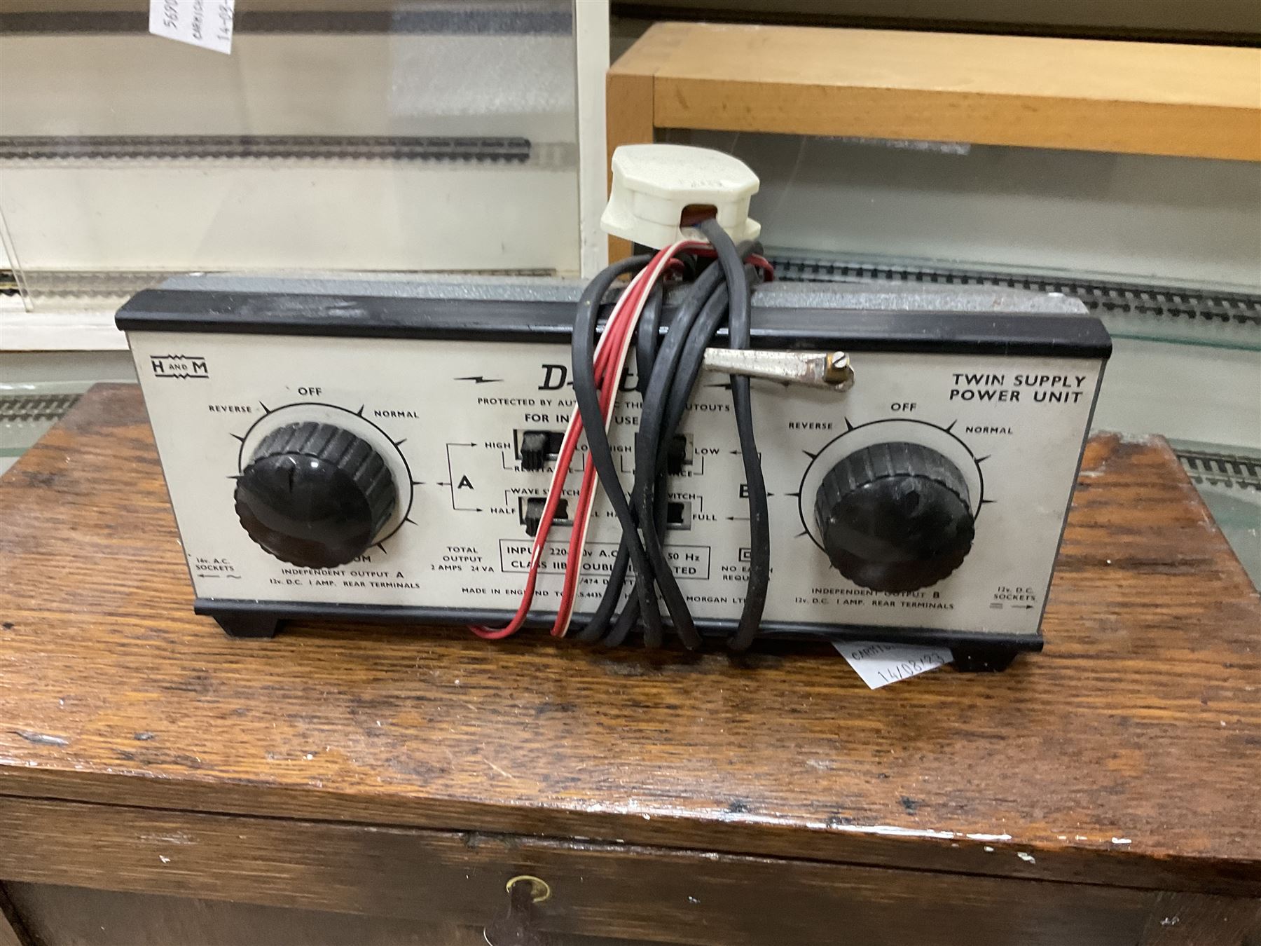 Six shelved cabinets for displaying ‘00’ gauge locomotives comprising plain plywood and white painted examples with track applied to various shelves, largest H63cm, W107cm, D27cm; Collection of tools for building model locomotives to include Weller PU-2D Soldering Pencil and Standard Tip Soldering Iron 20W/230V, Humbrol Modellers Airbrush, Power Supply Units and two wooden chests one of which housing a collection of tools including tweezers, scalping tools, wrenches etc 