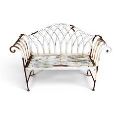 Small wrought metal two seat garden bench, finished in distressed white paint