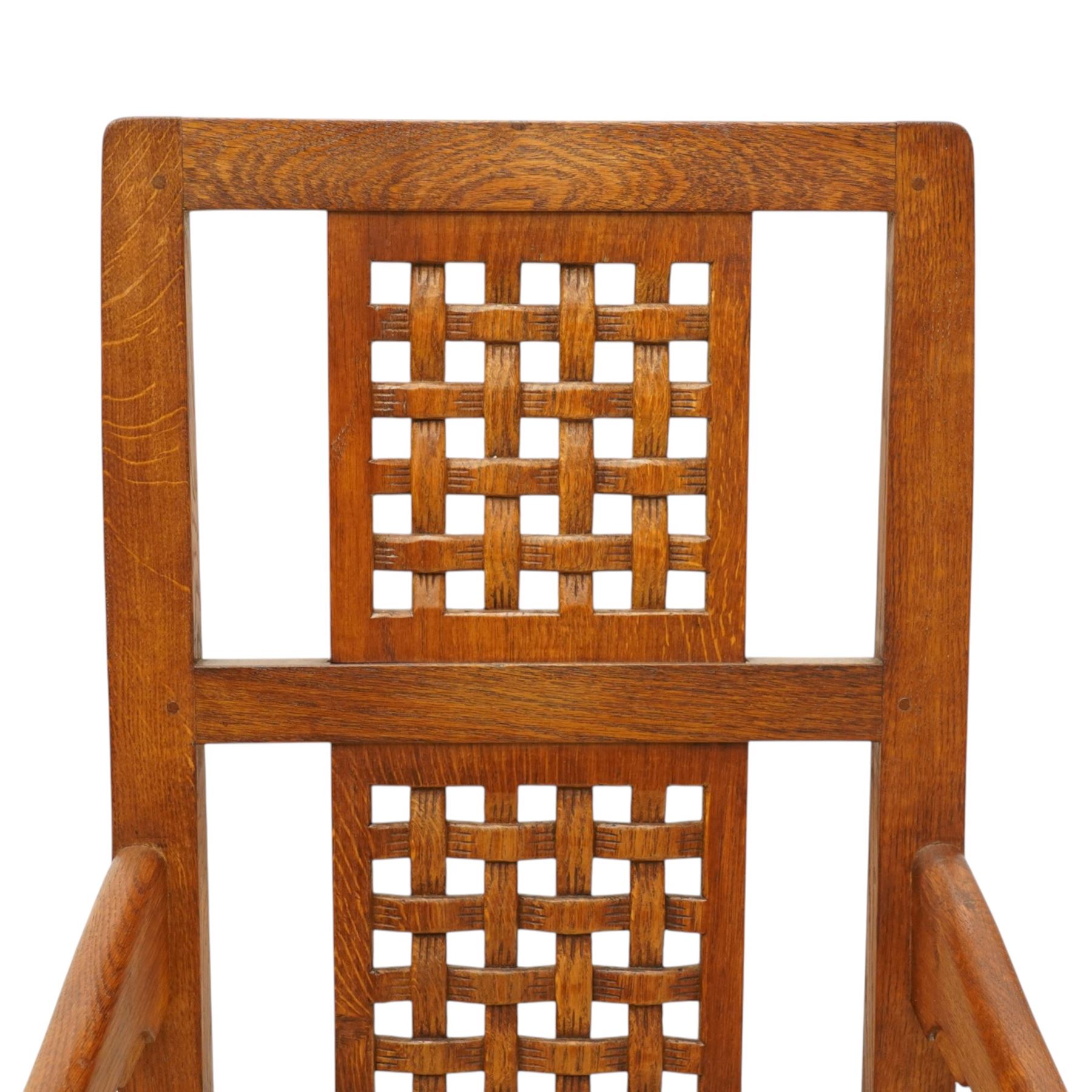 Mouseman - 1940's dark-honey oak rocking chair, high back with pierced double-lattice panel, over a beige-leather upholstered seat, shaped arm terminals above turned octagonal front-supports united by rocker base, with carved mouse signature, by the workshop of Robert Thompson of Kilburn
