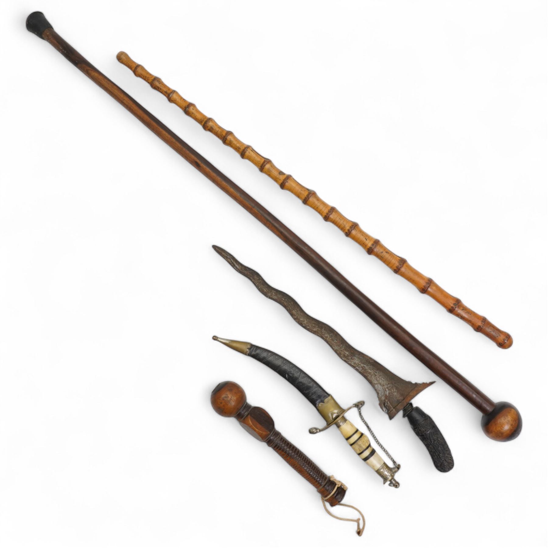 African knobkerrie, Malayan Kris, bamboo stick inscribed T.H.J. 29872, Arabian dagger with engraved curved blade and bone handle and a wooden gavel (4)