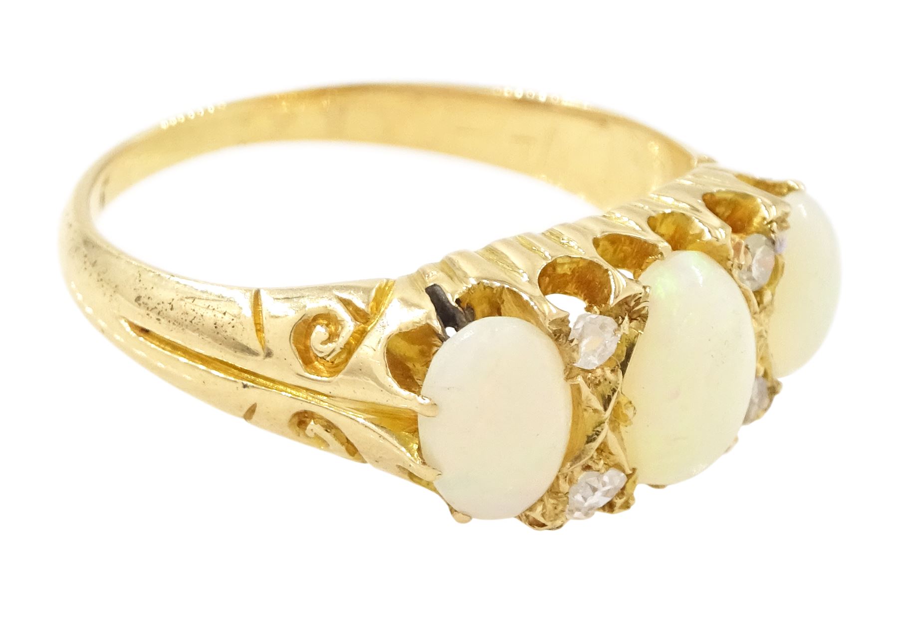 Early 20th century 18ct gold opal and diamond ring, three graduated oval cut opals, spaced by four accent diamonds