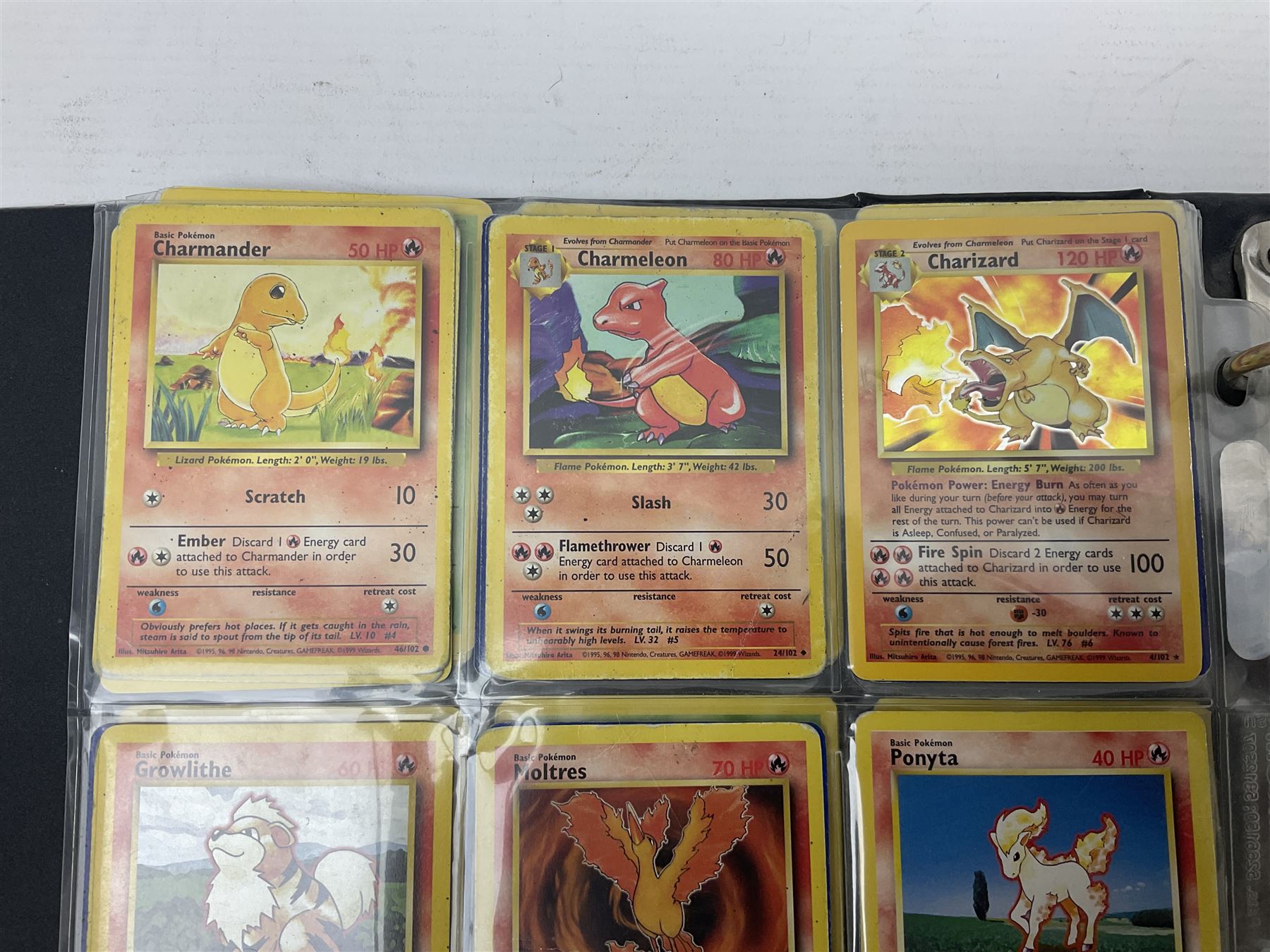 Collection of Pokemon trading cards, mostly 1999 Wizards Pokemon cards to include holo Charizard 4/102, first edition holo Machamp 8/102, further holographic cards; Dark Flareon 35/82 and Dark Vaporeon 45/82, cards from themed sets and 4th edition prints; 1998 Electronic Pokédex with cardboard boxes for themed decks Blackout, Overgrowth and Power Reserve Jungle, along with a large quantity of energy and trainer cards 