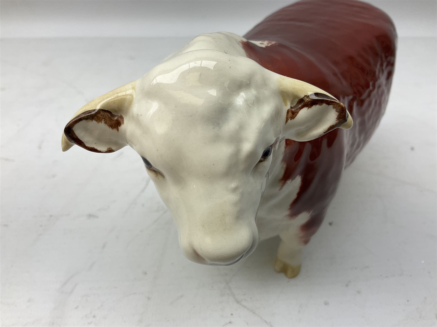 Three Beswick models comprising Hereford Bull no 949, 'CH Cutmil Cupie' Pug, and bay Shire horse, all with printed marks beneath
