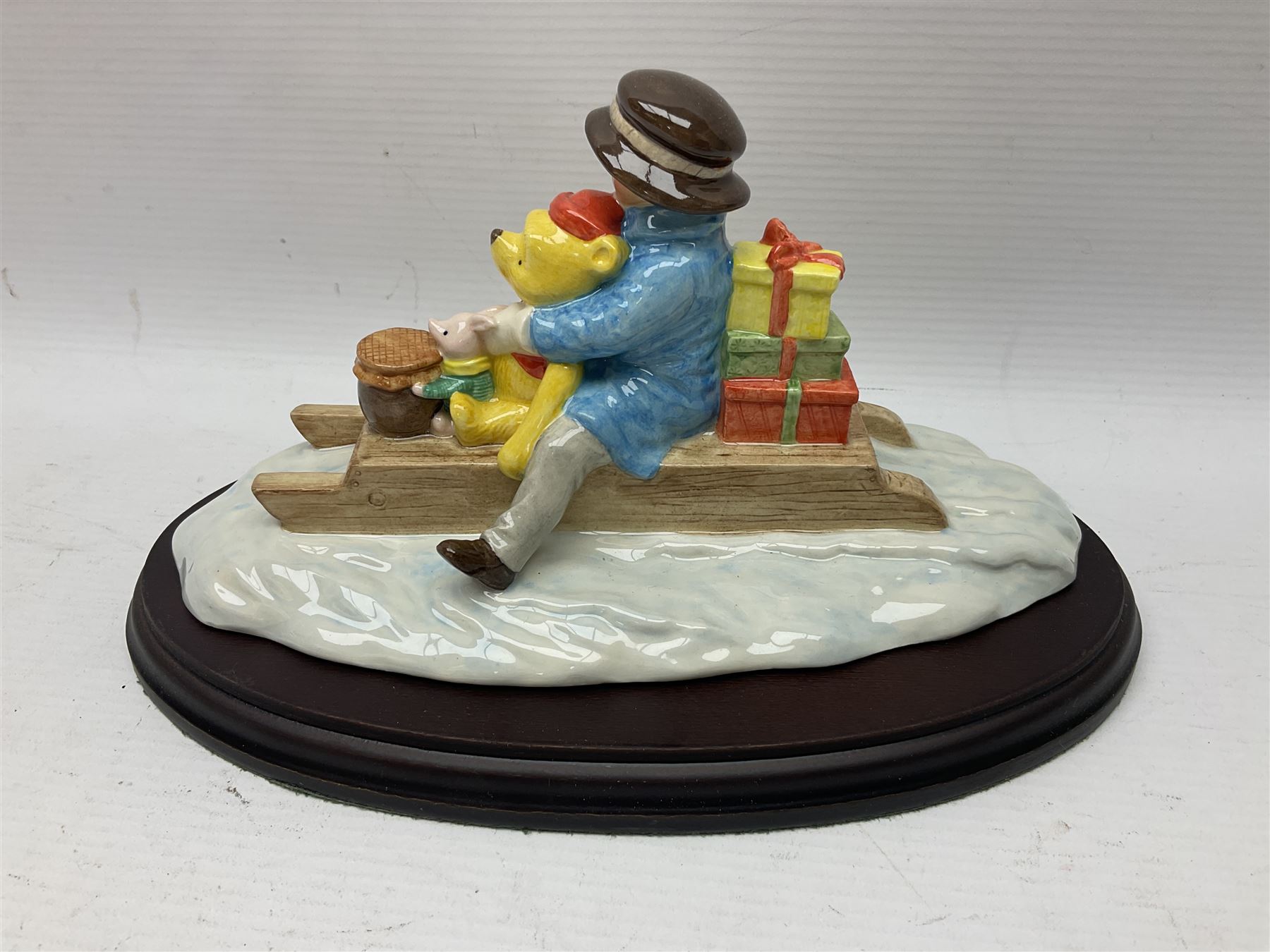 Nine Royal Doulton Winnie the Pooh Collection figures, including Oh Dear Bath Time's Here, Going Sledging, Tigger's Splash Time and Christopher Robin, together with a Royal Doulton Disney Showcase Jiminy Cricket figure, all boxed