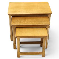 Mouseman - set of three adzed light oak nesting tables, each with rectangular top raised on octagonal legs joined by stretchers, with signature carved mouse, by the workshop of Robert Thompson, Kilburn