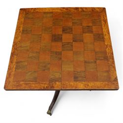 Early 20th century walnut chess table, square checkered veneered top with crossbanded edge, raise on a turned column based with acanthus craving, on three outswept legs terminating in brass paw caps above castors