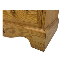 Pine chest of drawers topped with carved pediment with acorn and oak leaf motif, fitted with two short over three long drawers, standing on shaped apron base (W92, D46, H97cm); pine bedside cabinet, single drawer above paneled cupboard door enclosing open storage, shaped plinth base (W43, L32, H67cm)