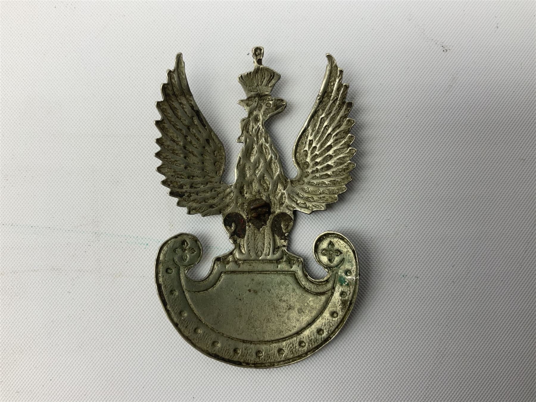 Three WW2 German visor cap badges comprising Police eagle, Political leaders eagle and Norwegian Quisling Party; all with fixings; and WW2 Polish visor cap badge (4)