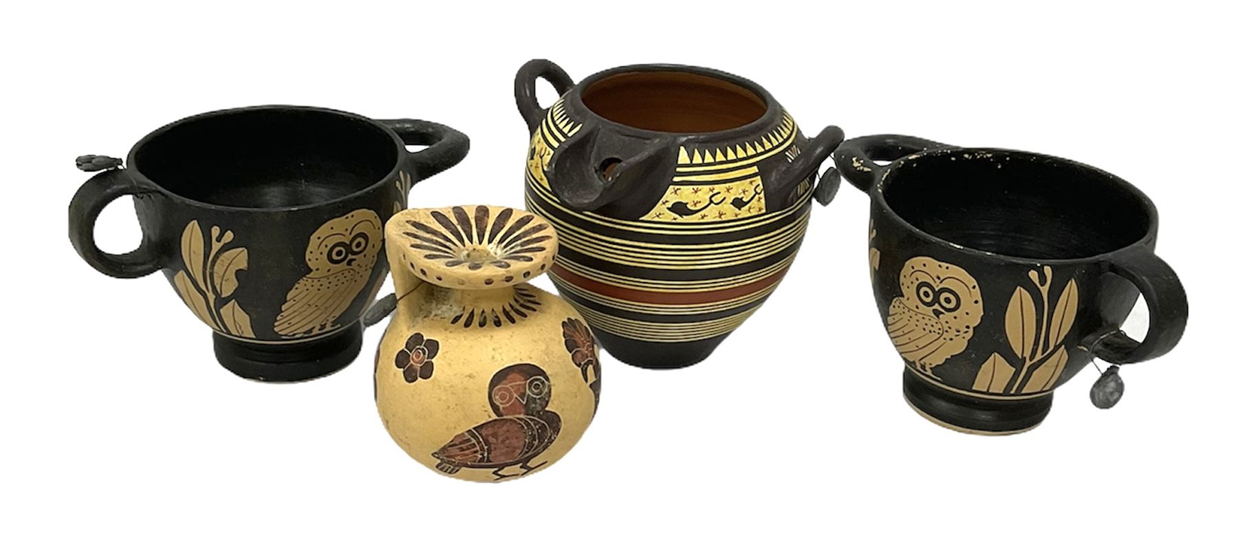 Four examples of reproduction Ancient Greek pottery, to include two skyphoi decorated with the Owl of Athena, standing between two sprays of olive in the manner of 5th century, both signed Attic 500 B.C,  terracotta twin handled vase with spout decorated in the Corinthian Geometric style, in the manner of 6th Century, signed beneath, and a further jug in the 7th Century Corinthian style decorated with flowers and birds