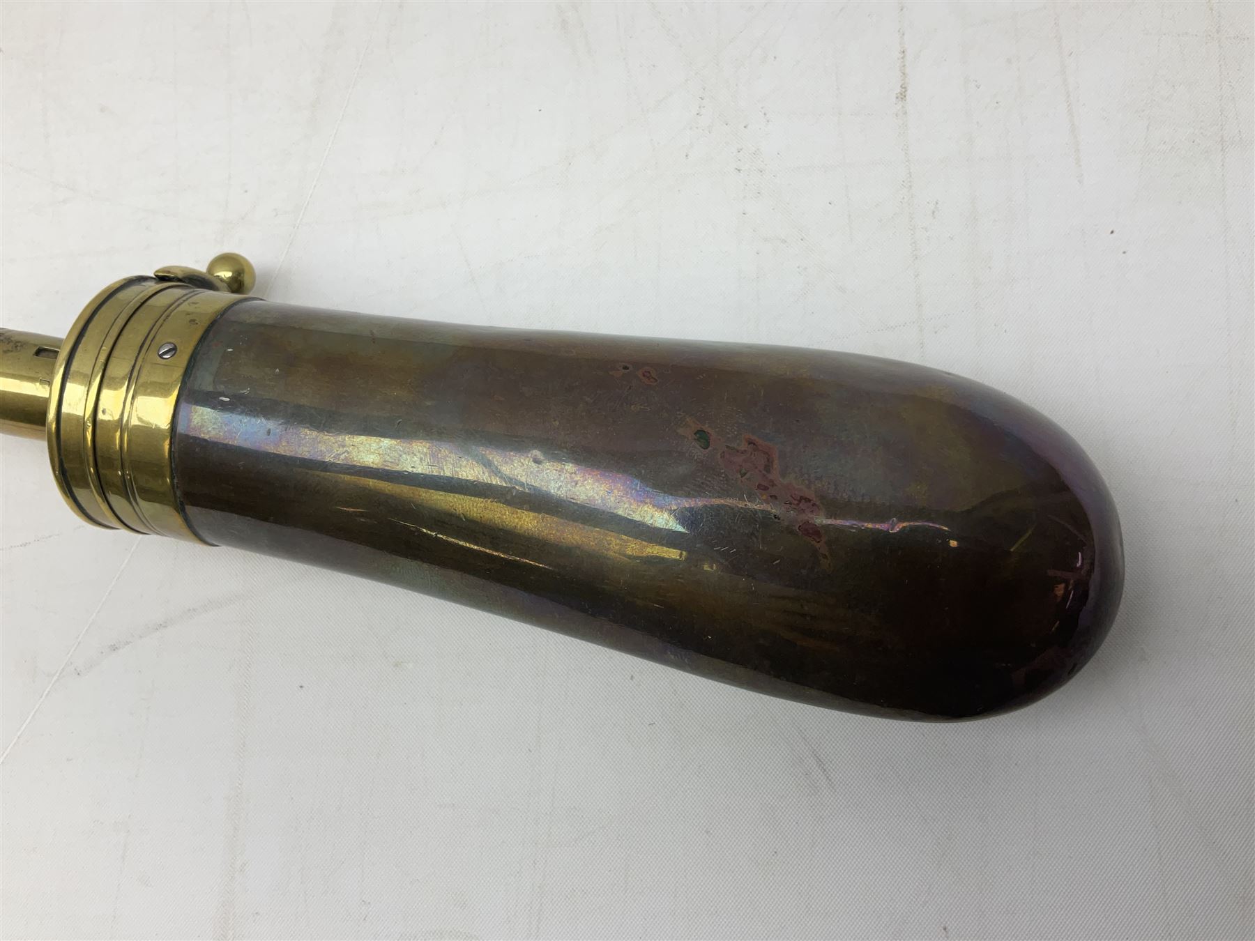 Two Sykes Patent brass mounted small load powder flasks with fire proof safety tops - one with slim plain copper body H17.5cm; the other with plain gun metal body H19cm (2)