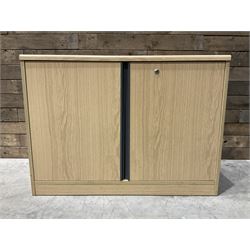 Light oak finish, two door cupboard enclosing single shelf