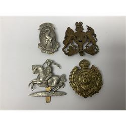 Twenty-one cap badges including 1st Queens Dragoon Guards, 14th/20th Kings Hussars, The Buffs, Royal Engineers, The Leinster, Cheshire Regiment, Kent Volunteer Fencibles etc (21)