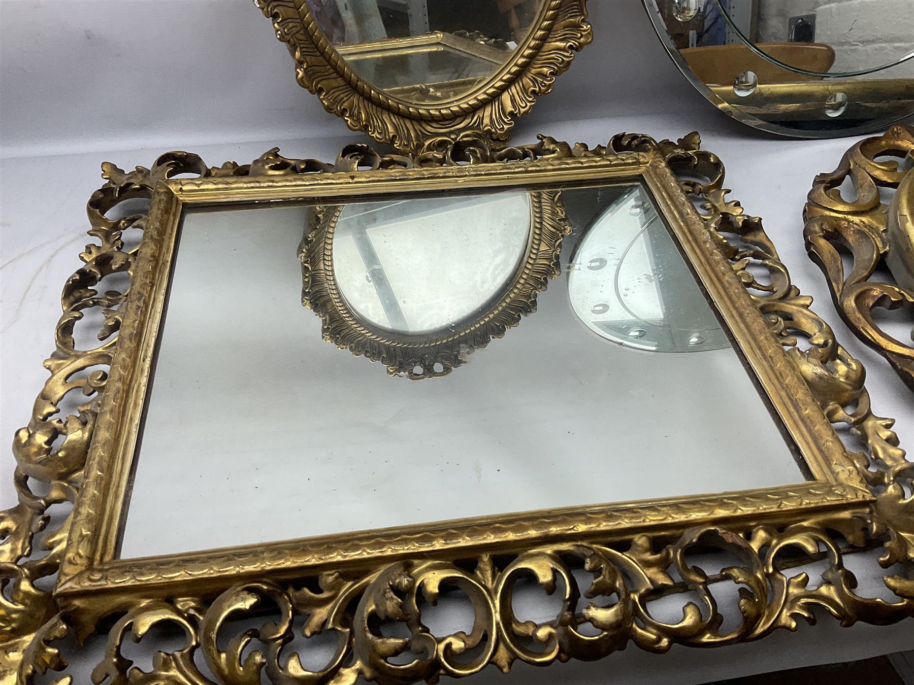 Three Rocco style gilt mirrors, together with another mirror, largest example H64cm 