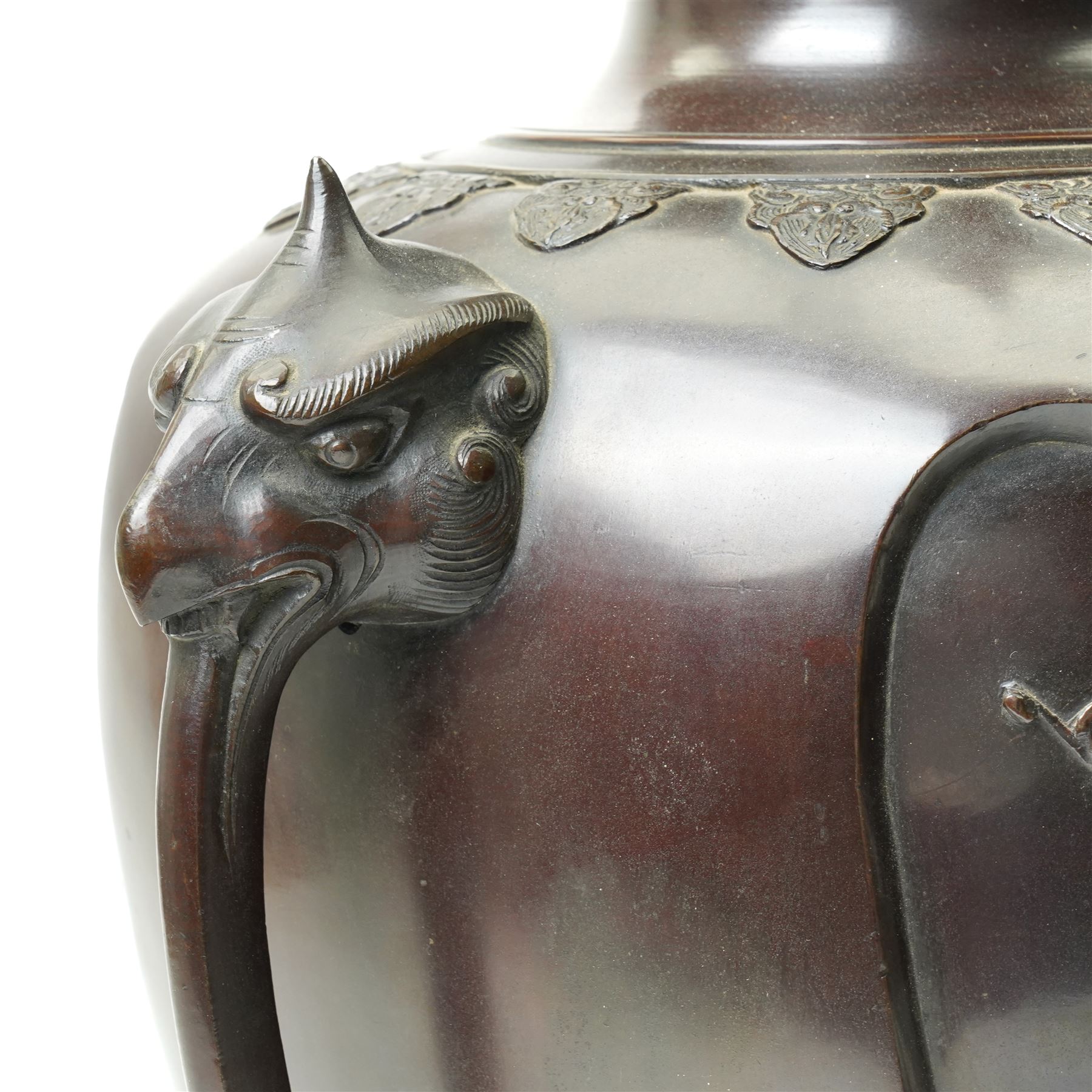 Japanese late Meiji period bronze koro and cover, surmounted by an eagle finial and with bird decoration in high relief to each side, twin elephant trunk handles, bearing indistinct character signature to one side, H82cm