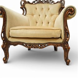 Late 19th century style carved hardwood armchair, the openwork crest rail with scrolling and foliate ornament, upholstered back and outscrolled arms with buttoning, loose seat cushion, nailhead trim, on carved cabriole legs