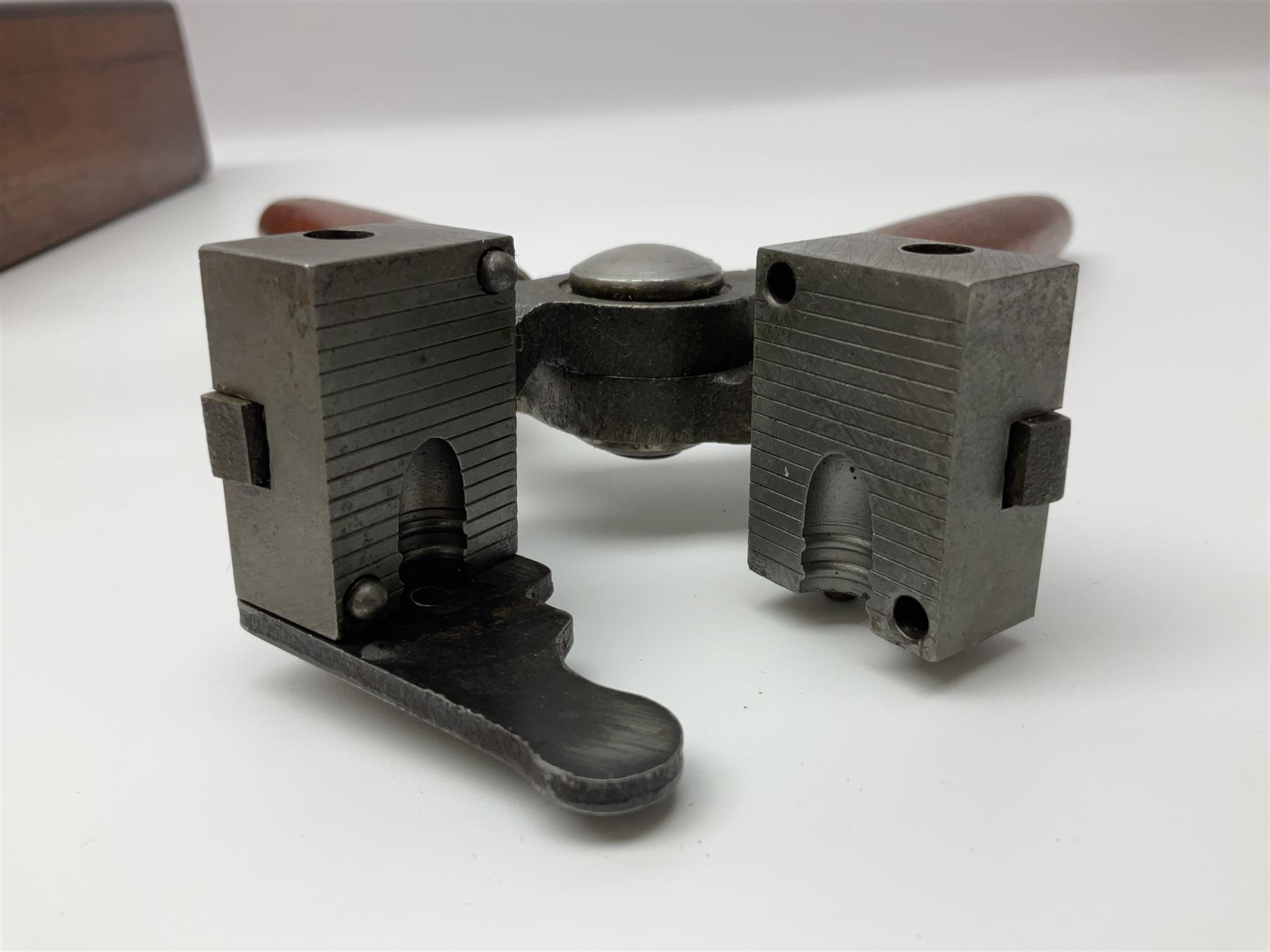 Three modern bullet moulds comprising Lee double cavity .44 calibre, boxed with instructions; and two Lyman .38 calibre; all in unrelated 19th century mahogany box