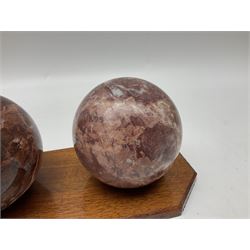 Set of three marble spheres on a elongated octagonal wooden base, H12cm