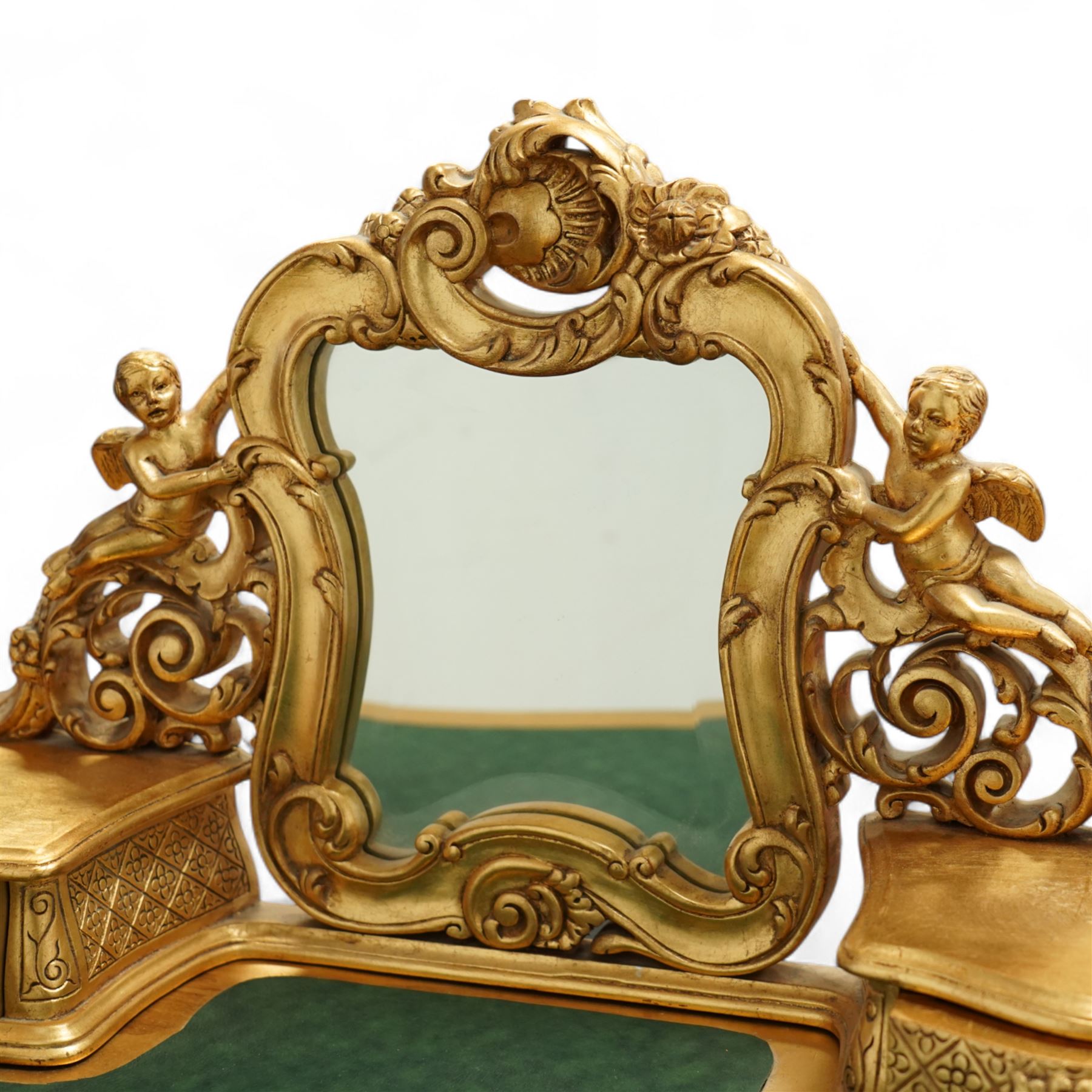 Louis XV style gold painted dressing table, serpentine top with green leather inset and mirrored back with floral garland decoration to frieze and legs, united by curved stretcher with central floral finial 