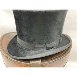 Early 20th century black silk top hat by Woodrow of Manchester and London, with manufacturer's stamp to the silk lined interior, housed in fitted tan leather hat box with removable internal compartments with straps, brass escutcheon and engraved plaque, hat internal measurements approx 20cm x 15cm