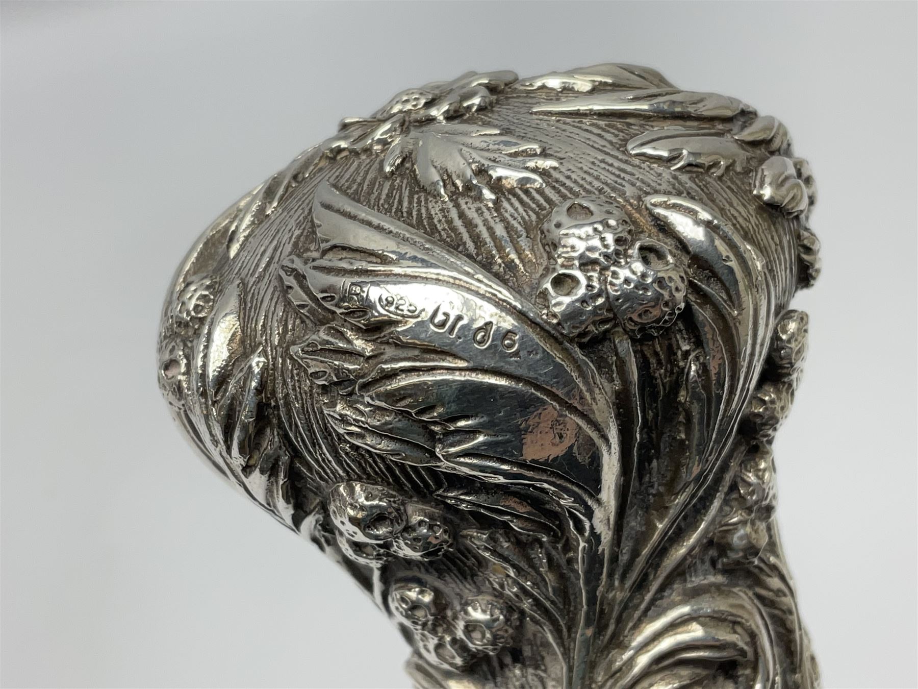Silver topped walking cane, with embossed decoration in the Victorian taste of flowers, berries and acanthus leaves, stamped 925, upon an ebonised shaft, L94cm