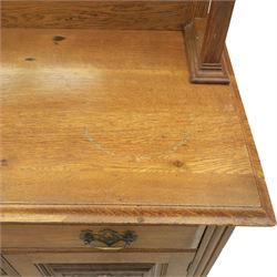 Arts and Crafts oak mirror back sideboard, the bevelled rectangular mirror set within a back with foliate carved panels, with turned baluster and knopped supports, upon a base with moulded top above three drawers  and three cupboard doors, two with carved foliate detail, upon four shaped bracket feet